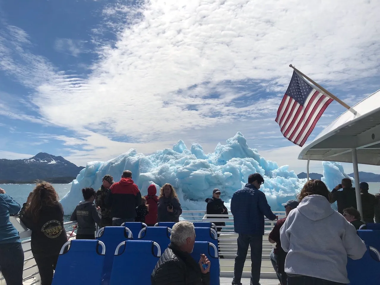 Passengers watching the icebergs of Columbia Bay from the boat's open stern deck
